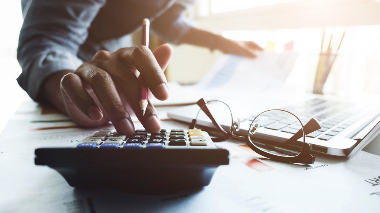Staff Boom Claims Administrators Page Banner - Corporate Man Using Calculator